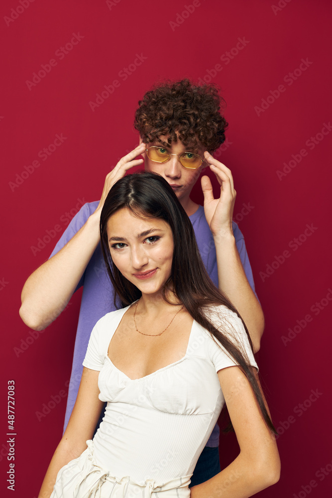 a young couple summer style posing fashion emotions red background a young couple summer style posing fashion emotions red background