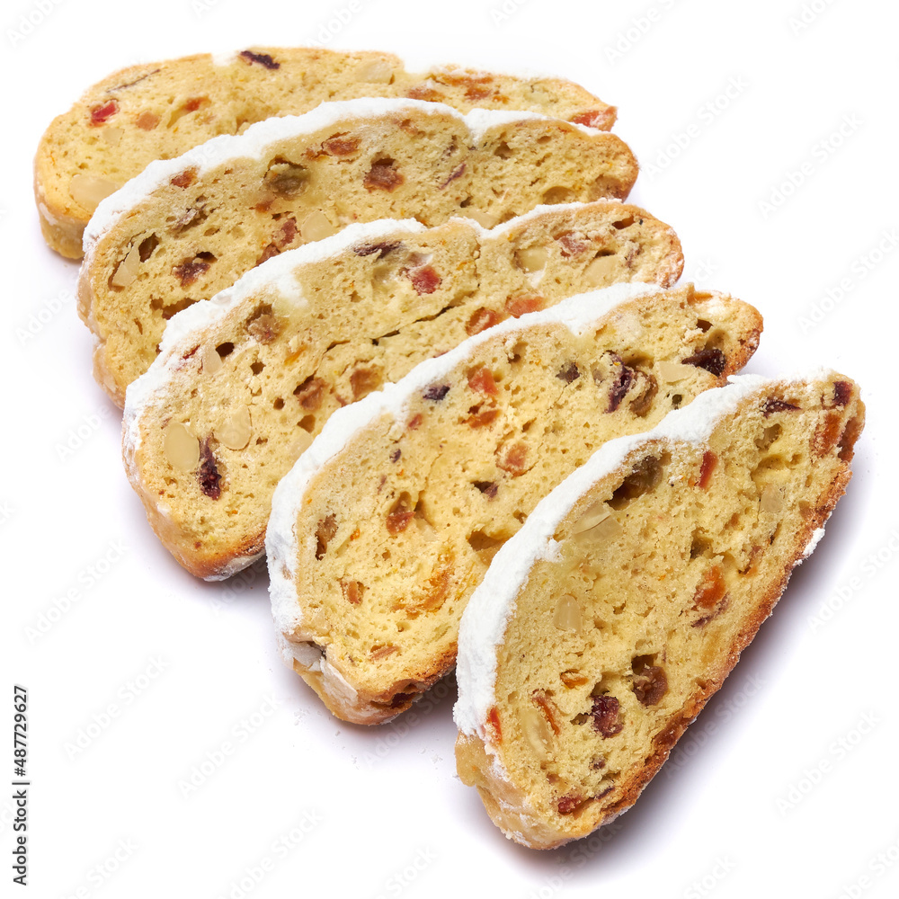 Sliced Traditional Christmas stollen cake with marzipan and dried fruit isolated on white background