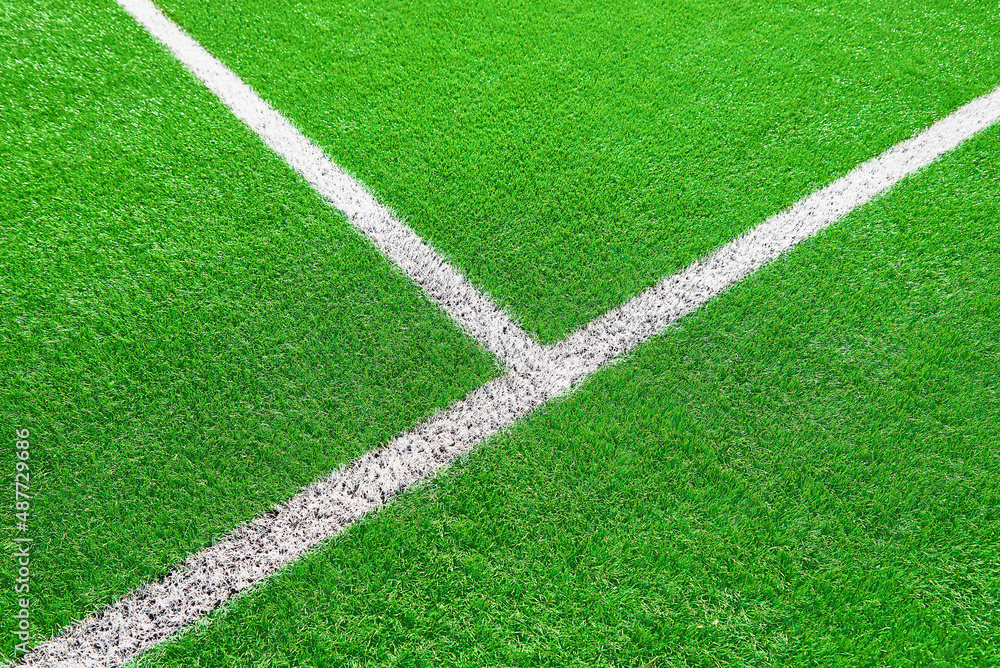 Part of football or soccer field close up, Artifical green grass with white border lines, Astroturf at stadium for spart games Part of football or soccer field close up, Artifical green grass with white border lines, Astroturf at stadium for spart games