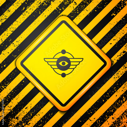 Black Egyptian symbol Winged sun icon isolated on yellow background. Warning sign. Vector