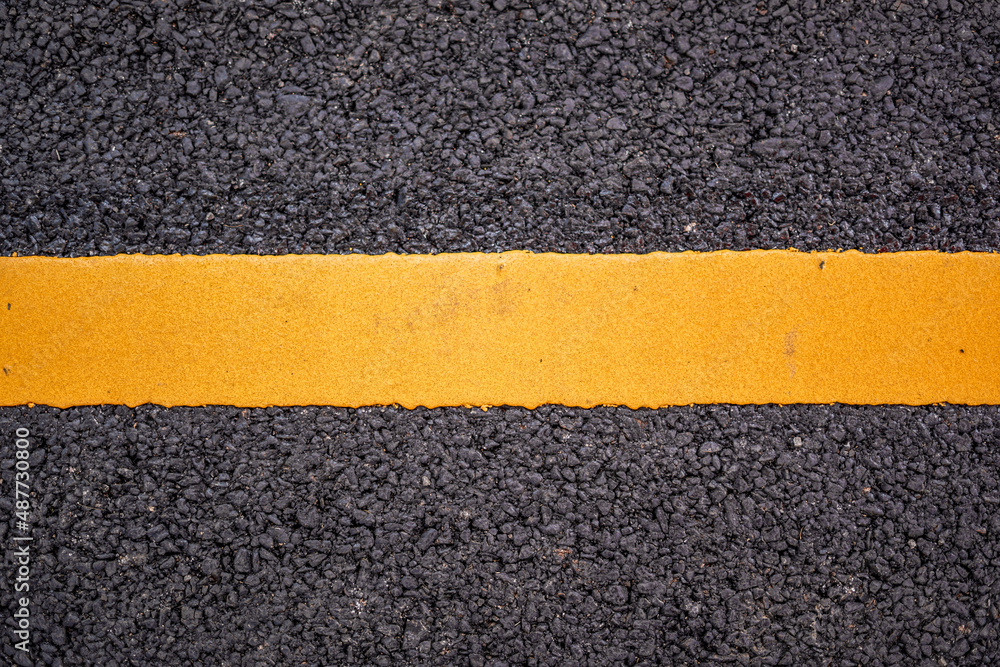 Fototapeta premium Asphalt road surface with yellow line background