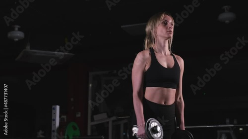 Woman exercising her arms with dumbbells