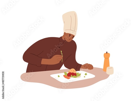 Chef cook adding condiment to restaurant dish. Professional cooking, preparin...