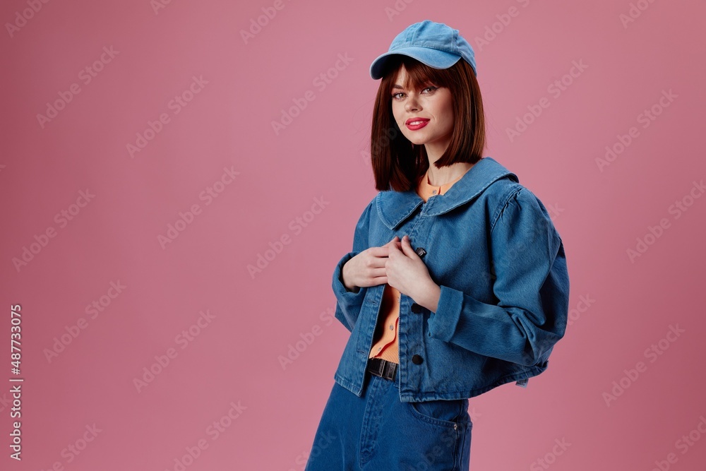 Pretty young female denim cap red lips glamor fashion pink background unaltered Pretty young female denim cap red lips glamor fashion pink background unaltered