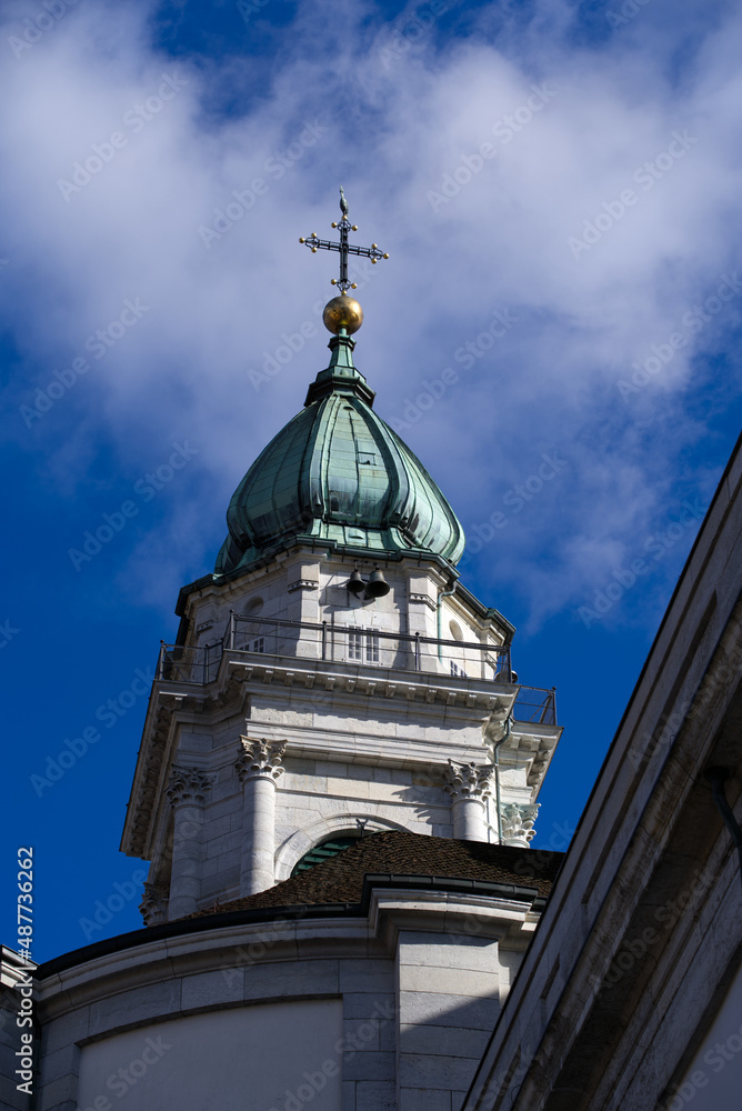 Fototapeta premium Historic colorful house facades at medieval alley with cathedral St. Ursen in the background at the old town of Solothurn on a sunny winter day. Photo taken February 7th, 2022, Solothurn, Switzerland.