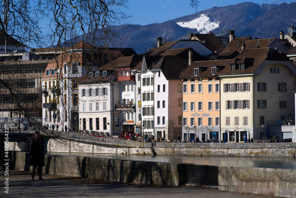 View at the old town of Solothurn seen form the Kreuzacker Bridge on a sunny winter day with river Aare in the foreground. Photo taken February 7th, 2022, Solothurn, Switzerland.