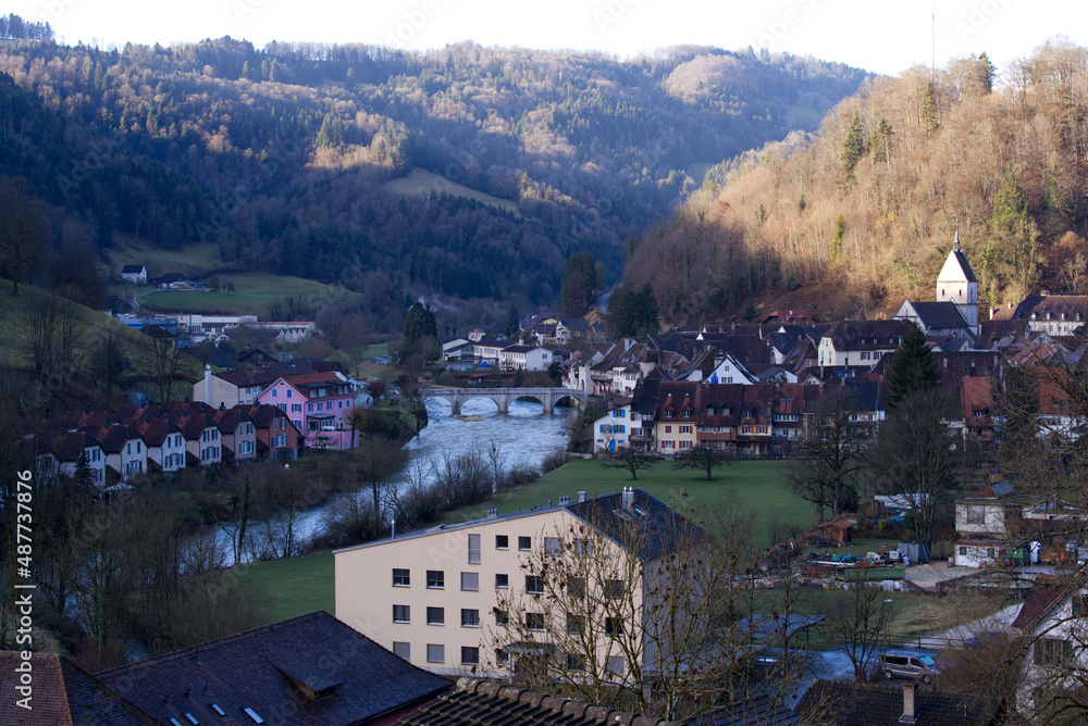 Aerial view of small medieval town St-Ursanne with river Doubs on a cloudy winter day. Photo taken February 7th, 2022, Saint-Ursanne, Switzerland.