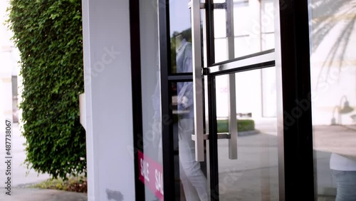 Wallpaper Mural Asian woman wearing medical face mask chooses clothes in a clothing store during coronavirus pandemic in department store. Store Re-opening Female Customer Choosing clothes after quarantine. Torontodigital.ca