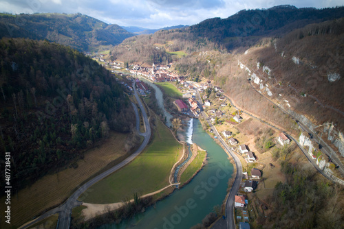 Aerial view of small medieval town St-Ursanne with river Doubs on a cloudy winter day. Photo taken February 7th, 2022, Saint-Ursanne, Switzerland.