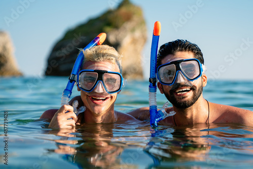 Happy friends enjoying summer vacation, travel during scuba diving.