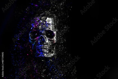 human silver skull on black background photo