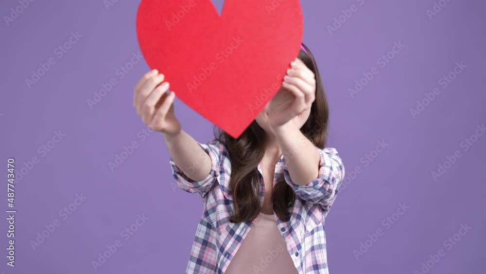 Childish lady playing big red card heart isolated vibrant color background Childish lady playing big red card heart isolated vibrant color background