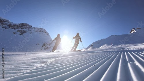 Professional skiers skiing fast ski turns on perfect ski slope. Panorama skiing with the best mountain. Cinematic slow motion skiing in winter. 4K PRORES 422