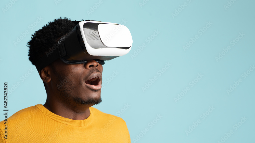 Amazed young black man having virtual reality glasses experience, closeup Amazed young black man having virtual reality glasses experience, closeup