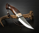 Hunting knife handmade on a black background.