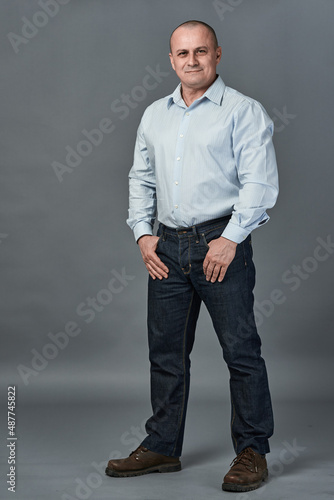 Mature businessman with hands in pockets