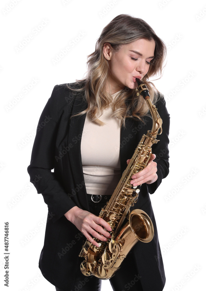 Fototapeta premium Beautiful young woman in elegant suit playing saxophone on white background