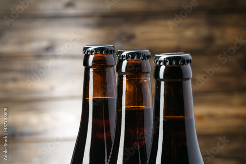 Beer bottle on a brown wooden table flat lay background with a copy space