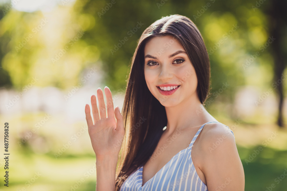 Portrait of charming good looking positive lady wave arm meet best friend congratulate enjoy free time outdoors Portrait of charming good looking positive lady wave arm meet best friend congratulate enjoy free time outdoors