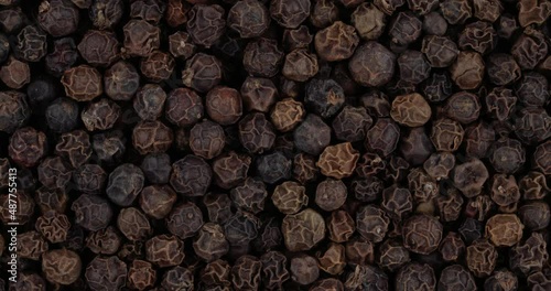 Top view of black pepper peppercorn rotating. Closeup. Macro.