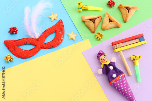 Purim celebration concept (jewish carnival holiday) over colorful background photo