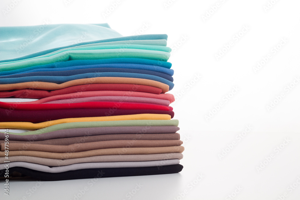 Rolls of bright colored fabric on a white background.