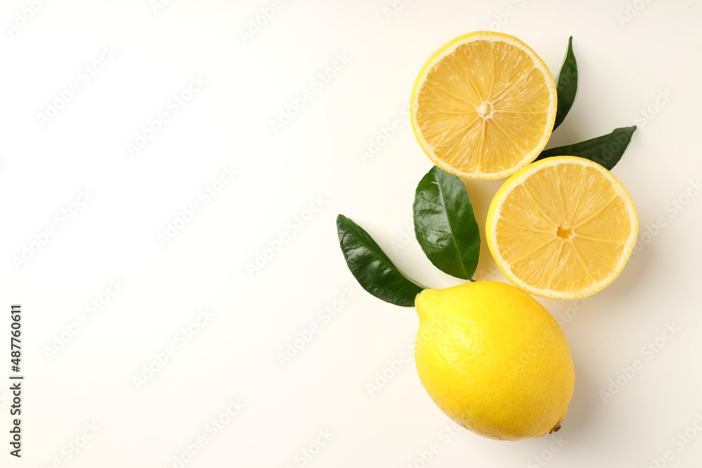 Lemons with leaves on white background, top view Lemons with leaves on white background, top view