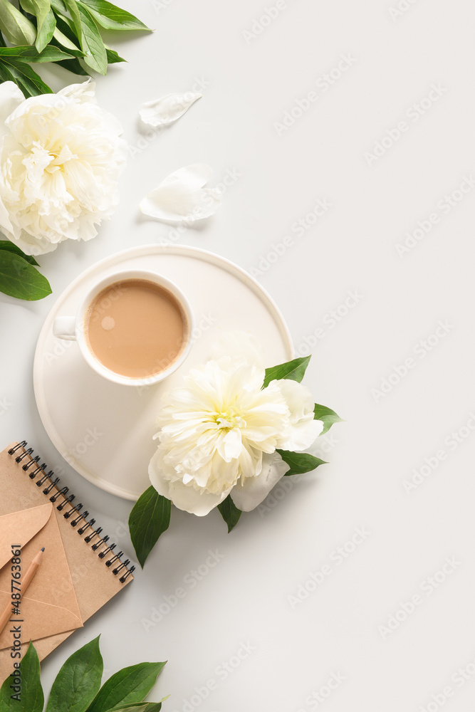 Coffee with white peonies flowers, craft envelope and letter on pastel gray background. Spring vertical greeting card, top view, flat lay. Mothers day. Romantic mood.