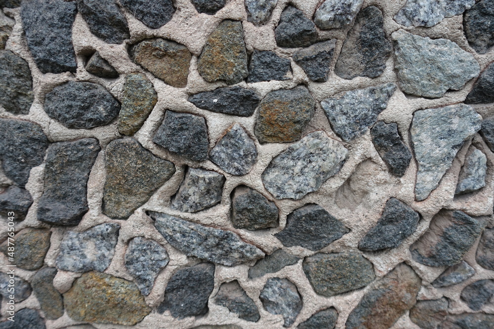 Close view of wall with dark gray gravel pebble dash Close view of wall with dark gray gravel pebble dash