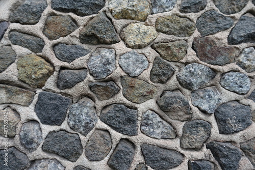 Background - wall with dark gray gravel pebble dash