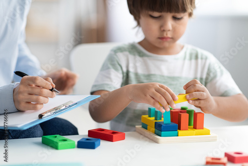 Photography Cute little boy during play therapy at child psychologist's office, professional