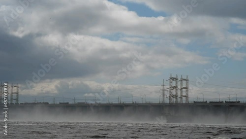 view of the bridge of the M5 road and the discharge of water at the hydroelectric power station across the Volga River near Zhigulevsk in gloomy weather.