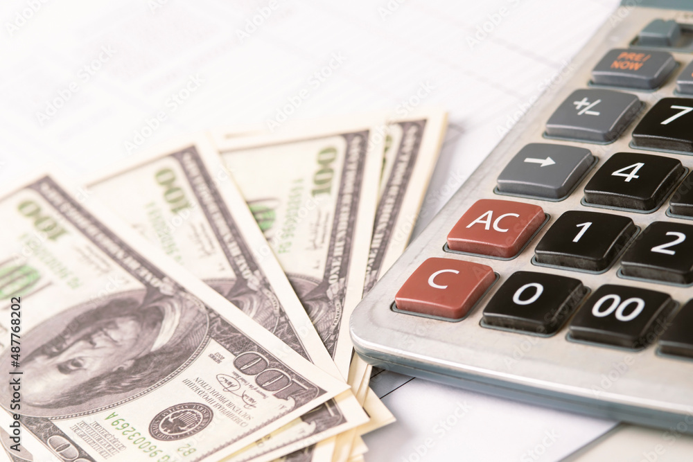 Money dollars and calculator, economy concept, money distribution. Euro. The crisis after the covid-19 pandemic. The dollar is falling or rising. Money dollars and calculator, economy concept, money distribution. Euro. The crisis after the covid-19 pandemic. The dollar is falling or rising.
