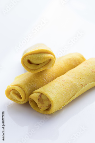 Stuffed pancakes or crepes rolls with chicken meat and cheese. Traditional Russian Shrovetide Maslenitsa festival meal. Food recipe background. photo