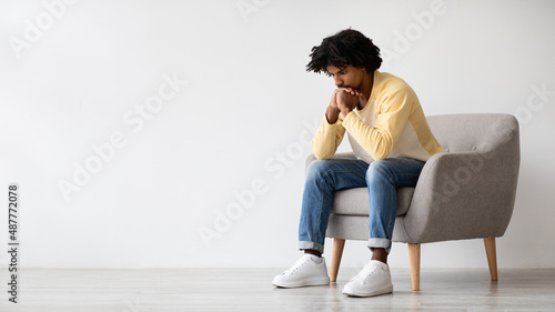 Heavy Thoughts. Portrait Of Pensive Young African American Male Sitting In Armchair