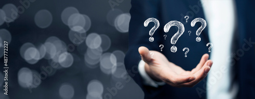 Naklejka Businessman hand hold interface question marks