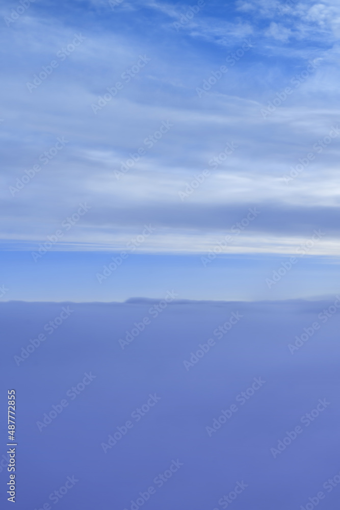 dreamy fluffy cloudscape from airplane porthole