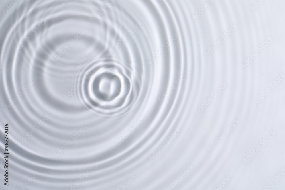 Closeup view of water with circles on light background