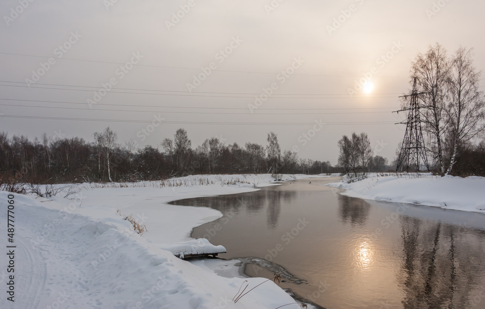 The February river reflects the sun The February river reflects the sun
