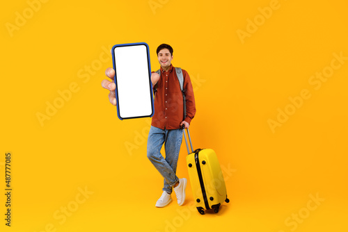 Male Tourist Showing Smartphone Empty Screen Standing Over Yellow Background
