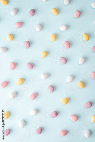 Happy Easter concept. Beautiful greeting card. Preparation for holiday. Easter candy chocolate eggs on trendy pastel blue background. Simple minimalism flat lay top view copy space