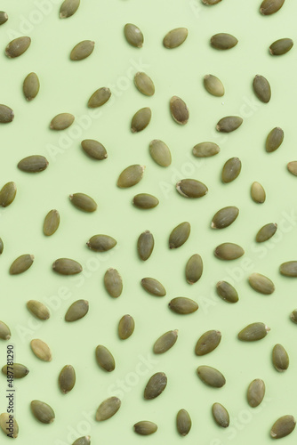Pumpkin seeds on a green background