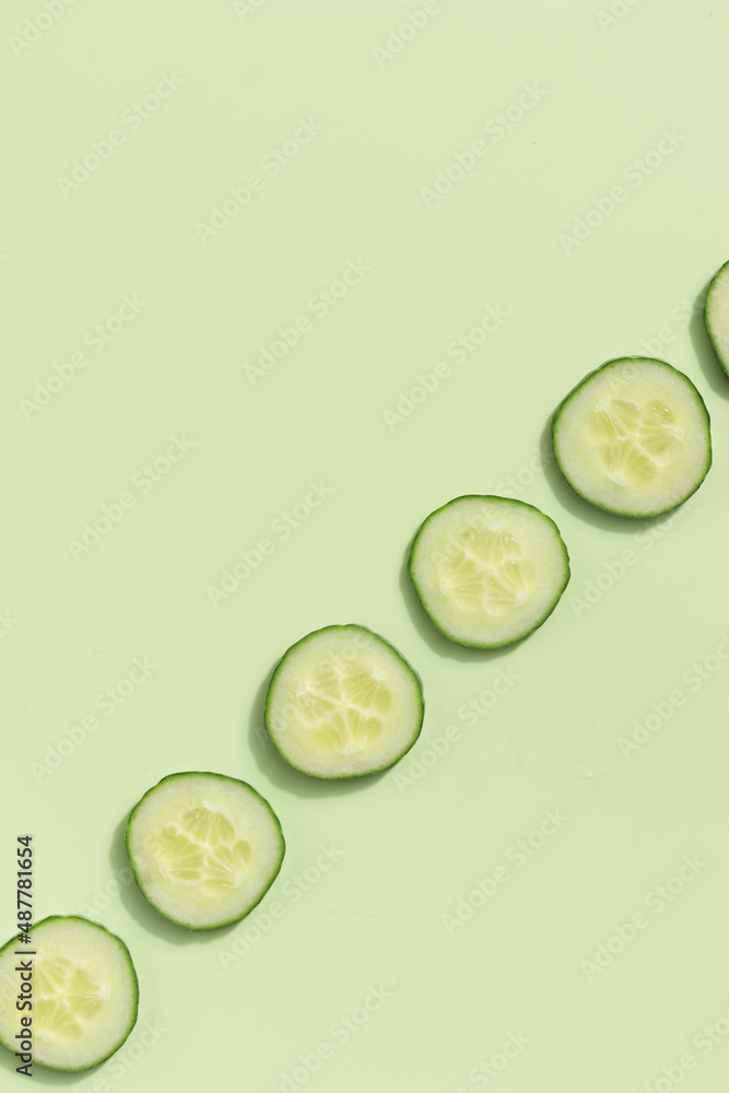 Cucumber slices on a green background Cucumber slices on a green background