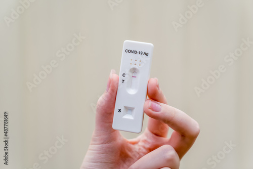 Hand holding Covid-19 rapid antigen test cassette with negative result of rapid diagnostic test