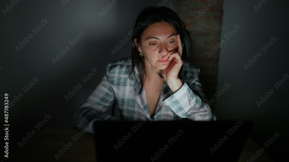 Tired woman in front of computer screen at night alone Tired woman in front of computer screen at night alone