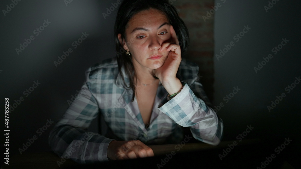 Tired woman in front of computer screen at night alone Tired woman in front of computer screen at night alone