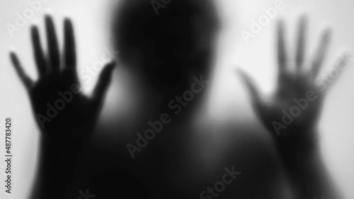 Spooky person behind glass scary person stuck in anxiety and depression concept monochrome