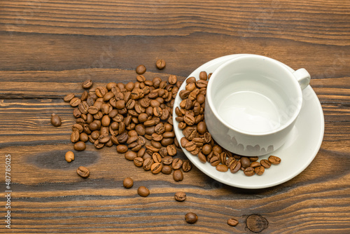 Empty white coffee cup and roasted coffee
