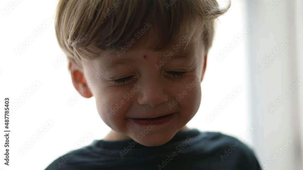 One cute goofy child eyes closed adorable kid opening eyes One cute goofy child eyes closed adorable kid opening eyes