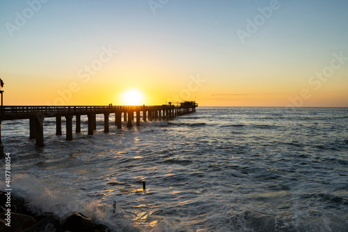 Old long wooden jetty at sunset
